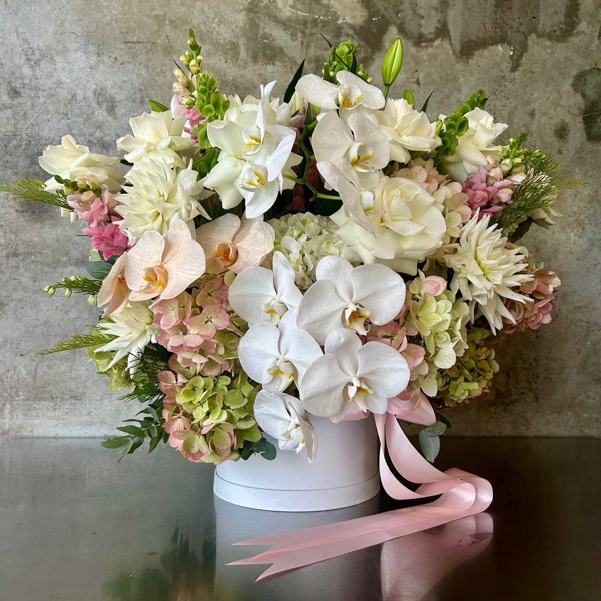 The Hatbox elegant flower arrangement with orchids roses and hydrangea by James St Florist Brisbane